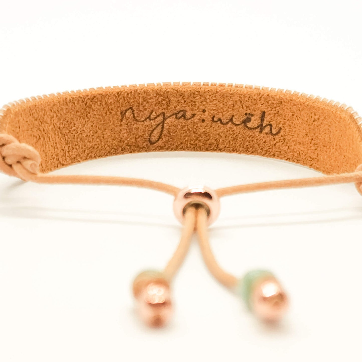 beaded bracelet back view showing leather stamped nyaweh logo